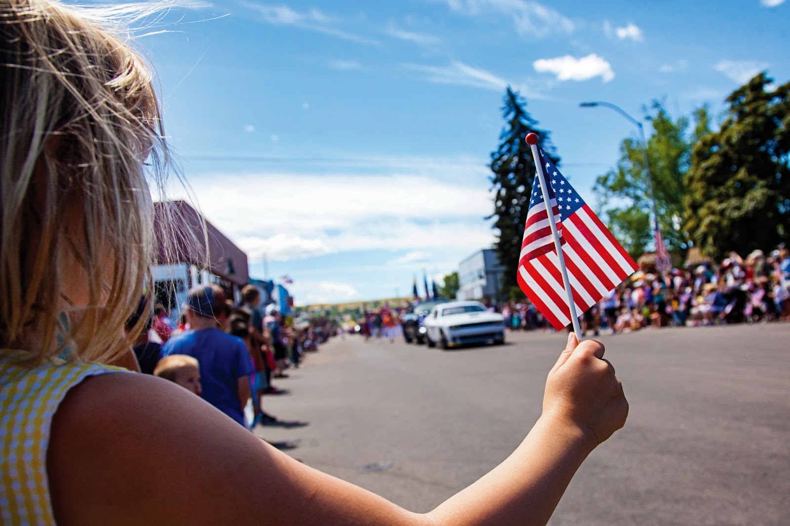 Girl waving American flag during 4th of July parade