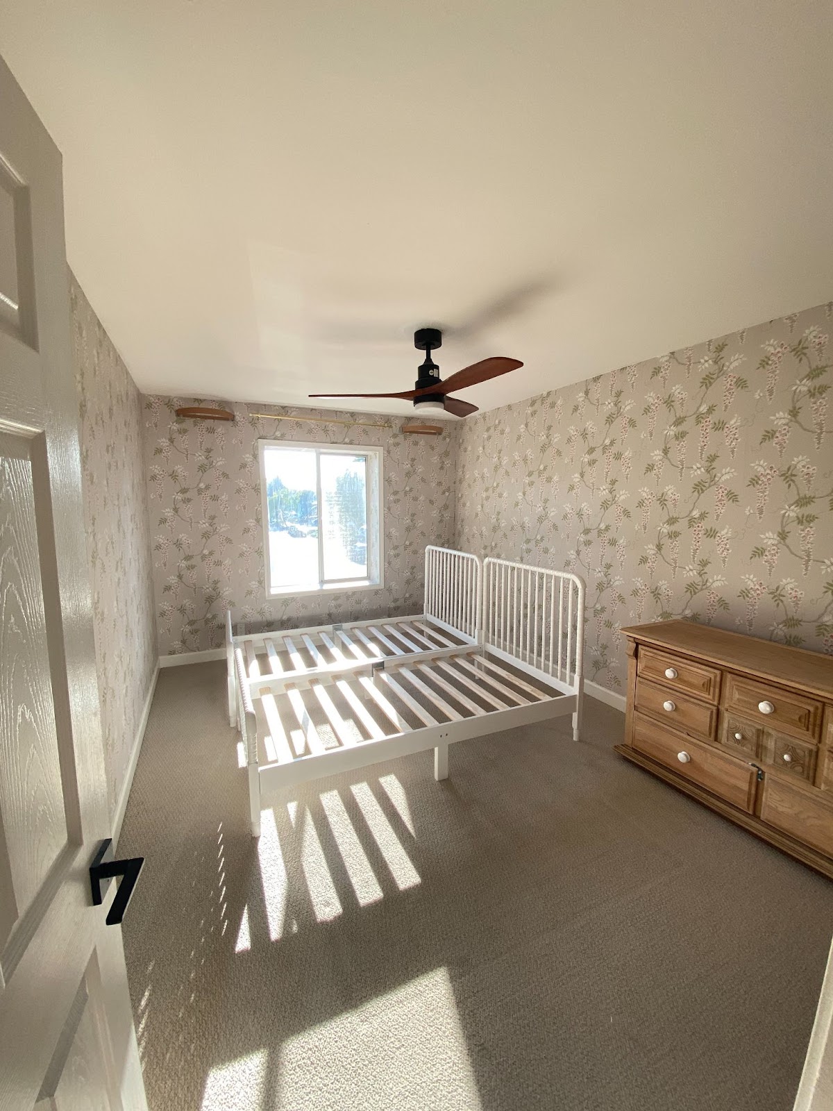 Picture of entire remodeled bedroom with wallpaper.