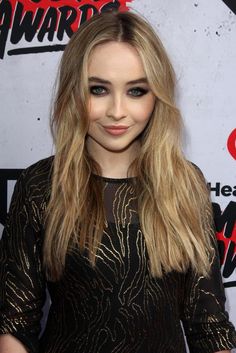 This contain an image of Sabrina Carpenter on a black dress