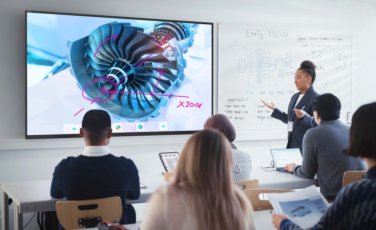 Students in higher education being taught using an interactive display