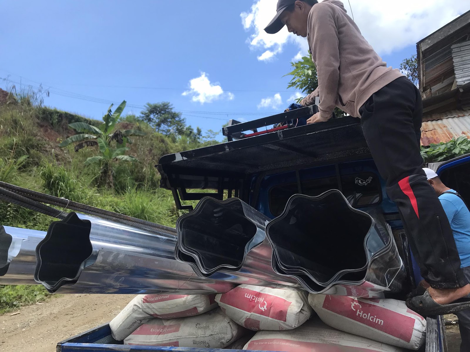 A worker preparing construction materials at Upper Paya Elementary School in the Philippines