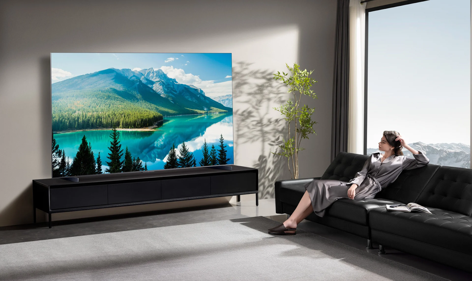 Woman looking at TCL QM8K QD-Mini LED TV in living room.