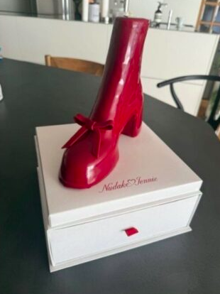 This contains an image of a stunning red boot-shaped cake, called "Rouge Heel,"