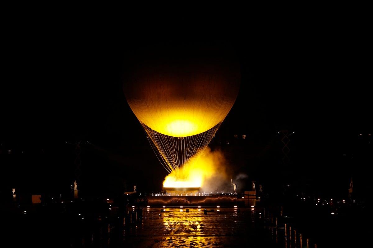 A hot air balloon with a fire in the air

Description automatically generated