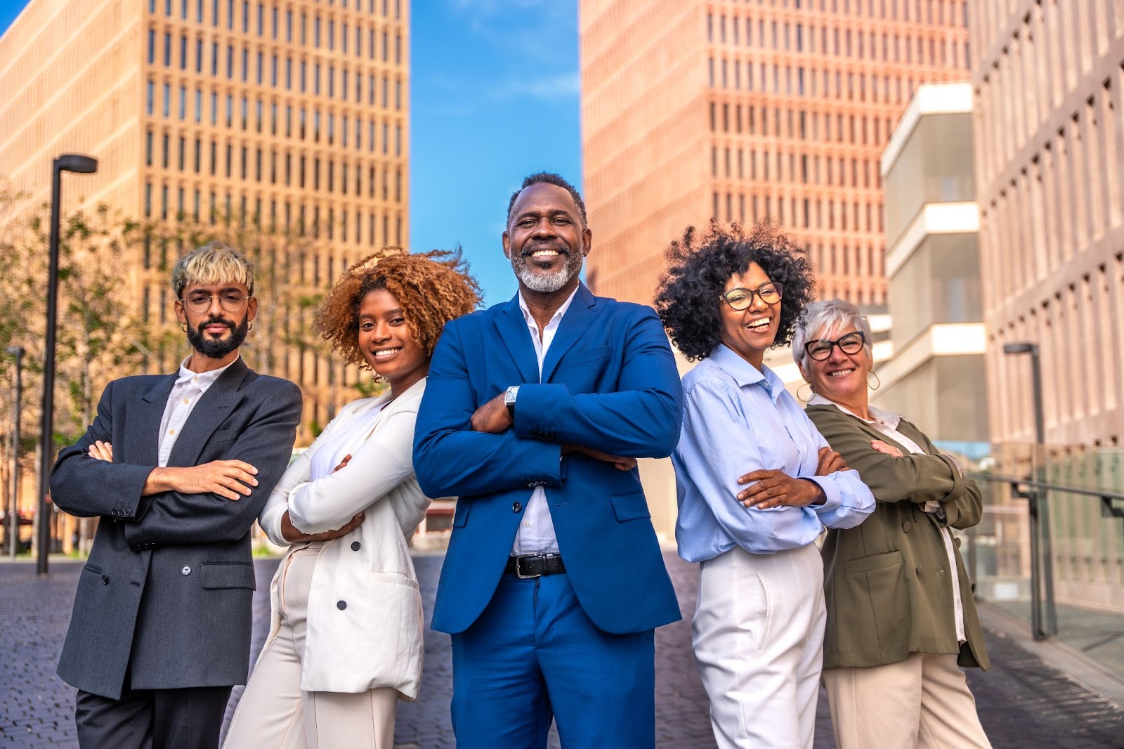 Group of business people in suits with buildings in the background. 