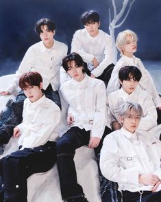 This contain ENHYPEN posing for a group photo in white shirts and black pants