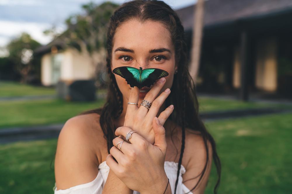 Portrait of a young girl with a butterfly on her face