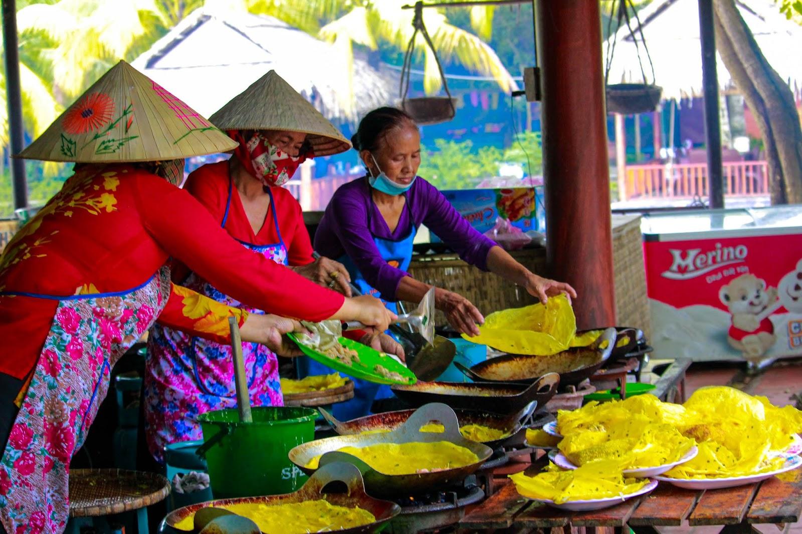 A group of women cooking foodDescription automatically generated