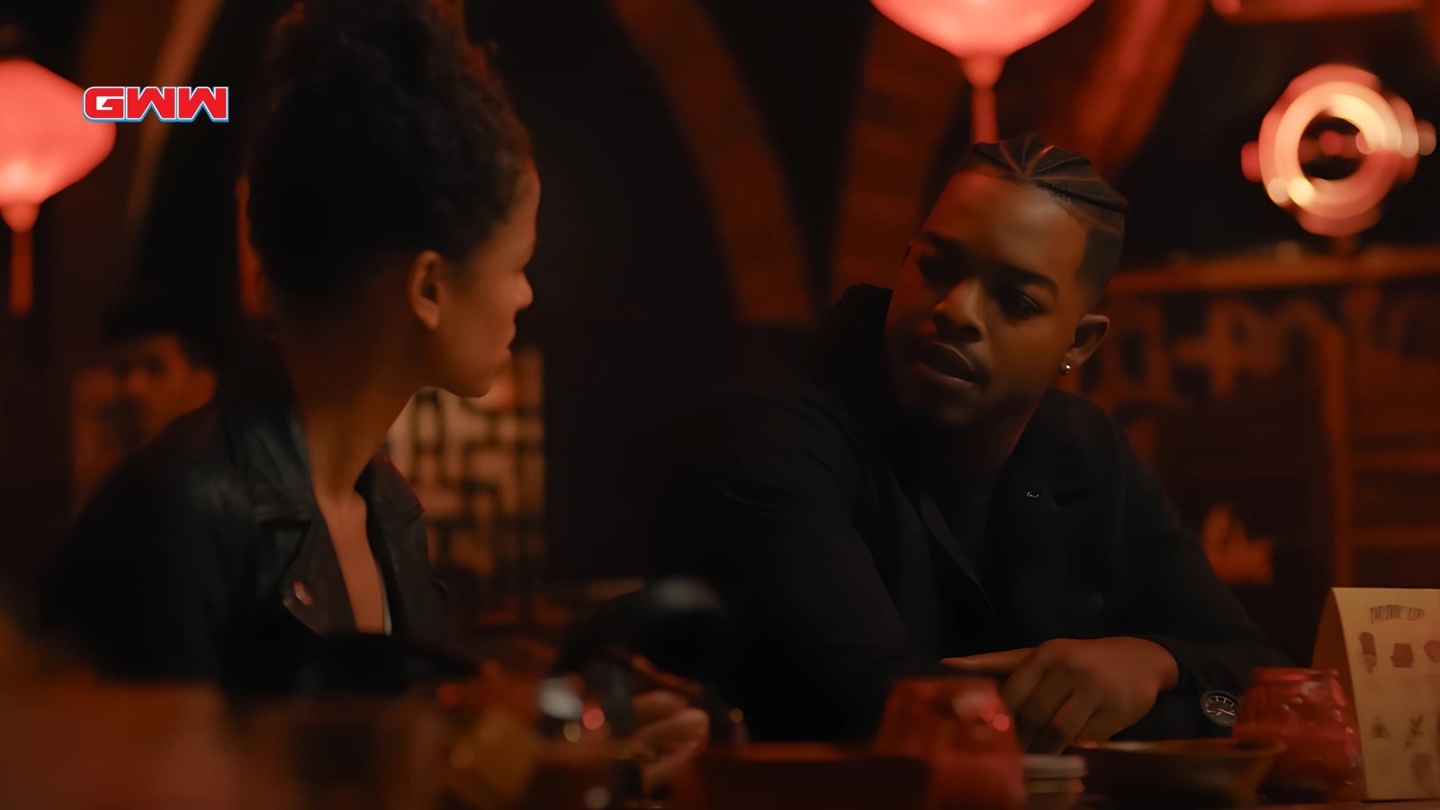 Gugu Mbatha-Raw and Stephan James in a dimly lit bar scene