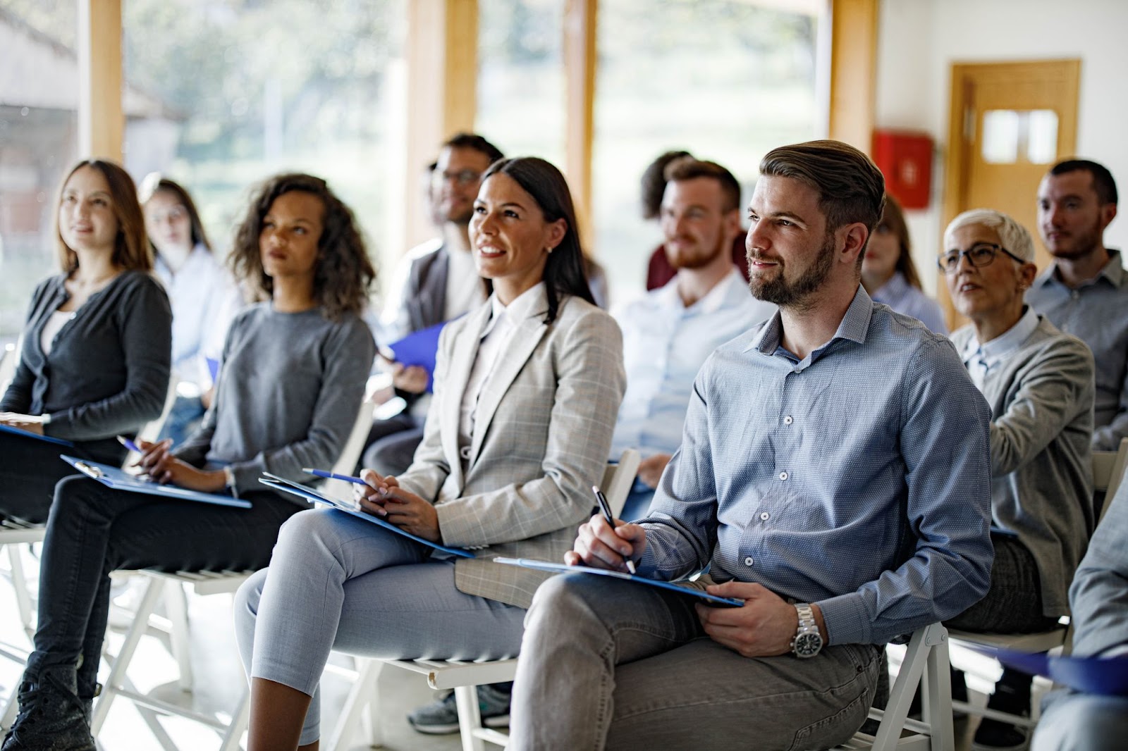 Free training provided at a financial institution. Several smiling nonprofit leaders.