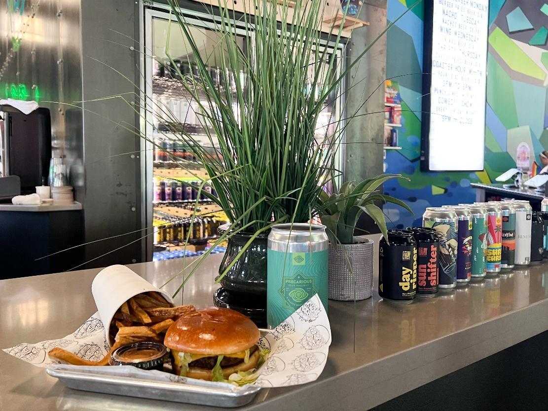 A burger and fries on a tray on a counter

Description automatically generated