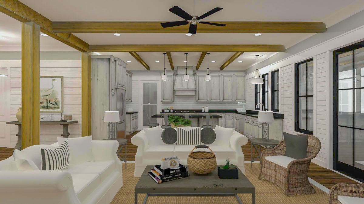 Living room with white sectionals, wicker chairs, and a wooden coffee table.