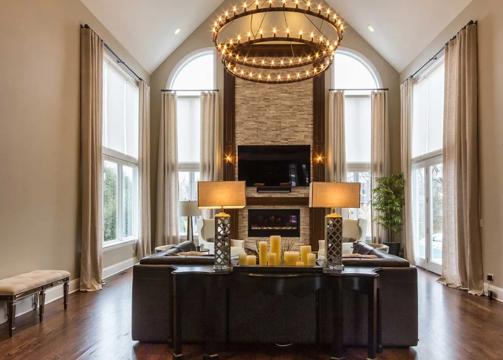 An elegant fireplace built within a floor-to-ceiling wall and wood mantel.