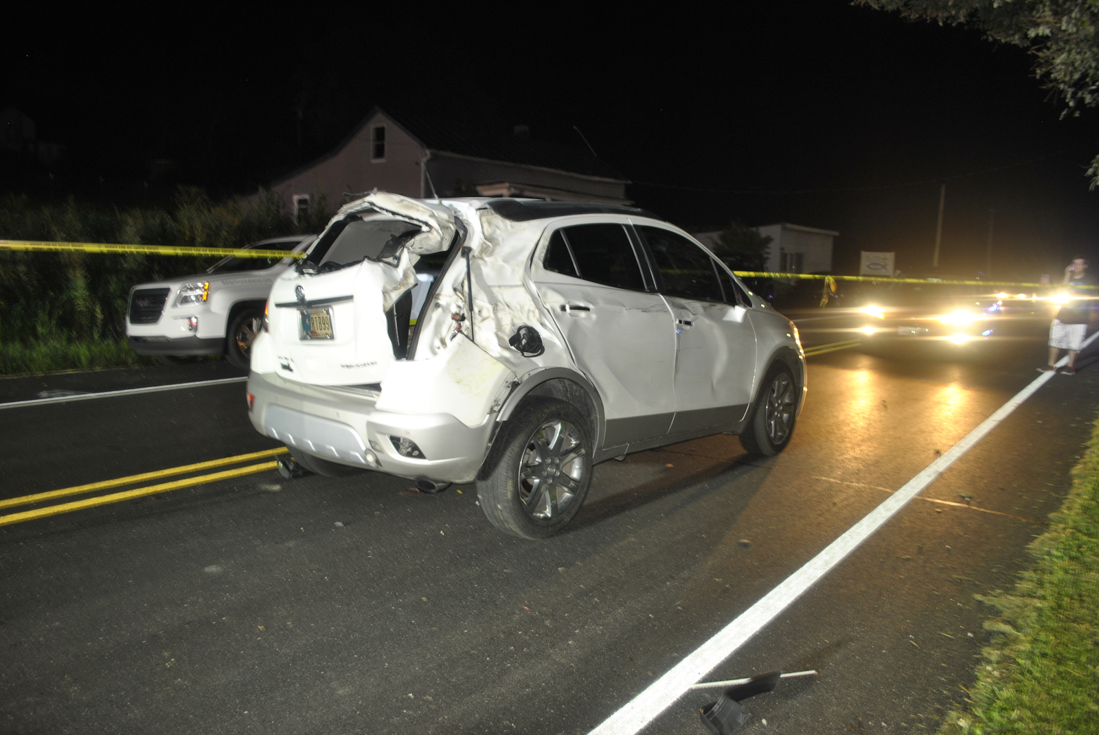 rear end car accident damage on an indiana road at night