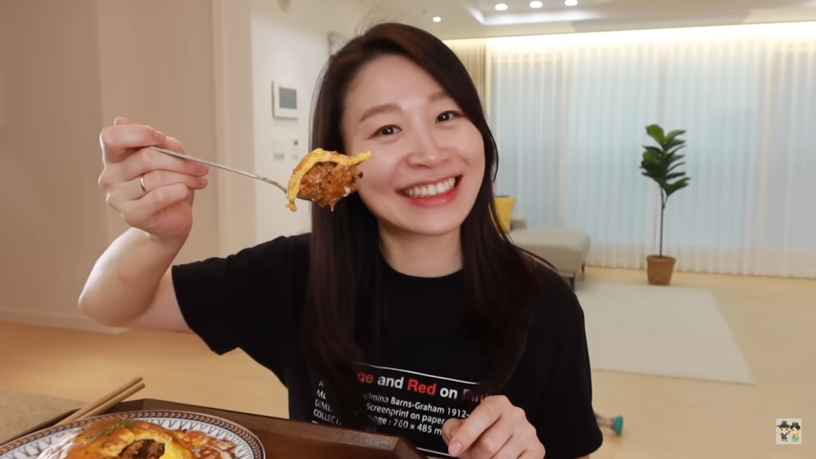 Claire smiling with a plate of their homemade Omurice