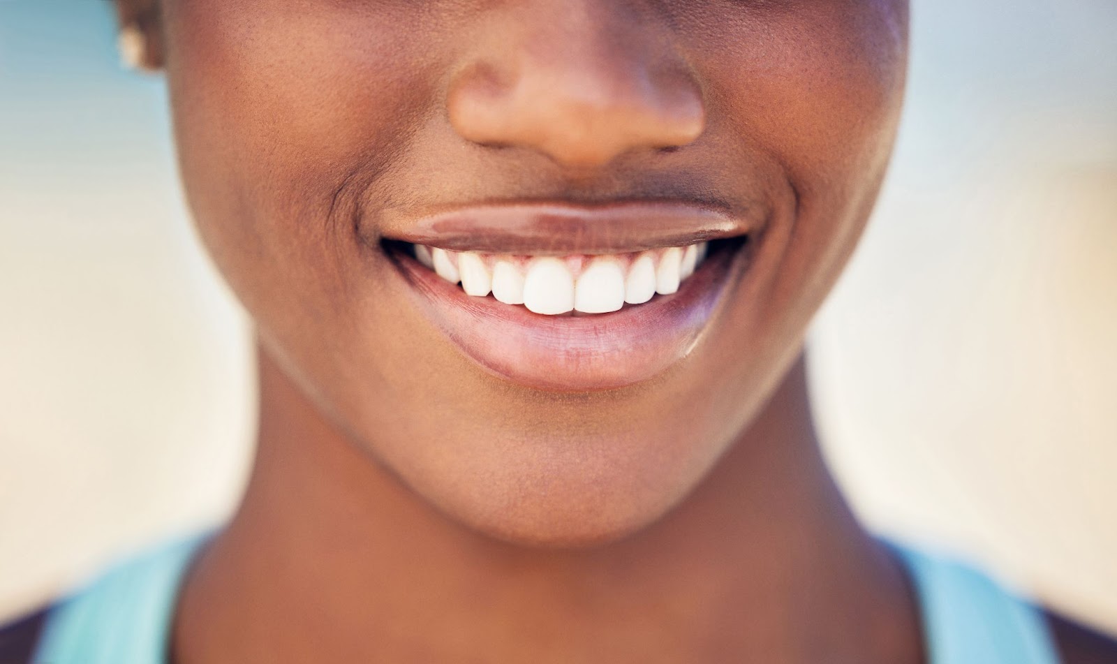 Woman smiling from the nose down. 