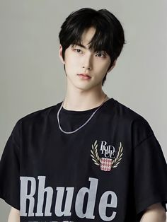 This contains  an image of  seugnhan with black hair wearing a t - shirt that says rhude