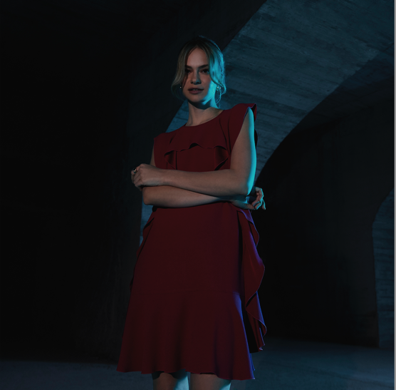 A person in a red dress

Description automatically generated