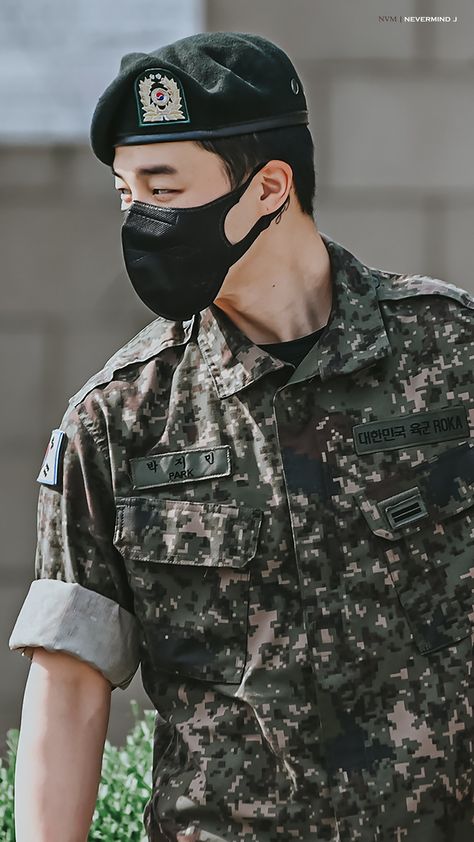 This  contain an image of Jimin wearing a black mask and camouflage uniform