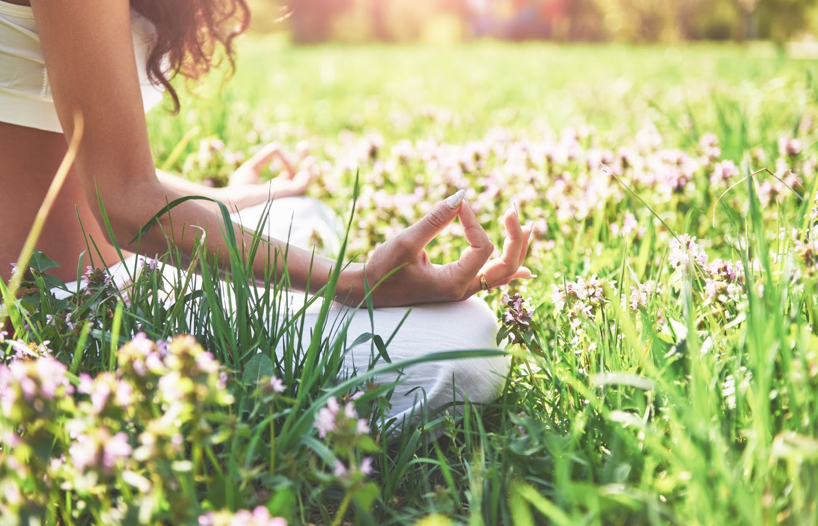 The picture shows a woman performing concentration in the nature.