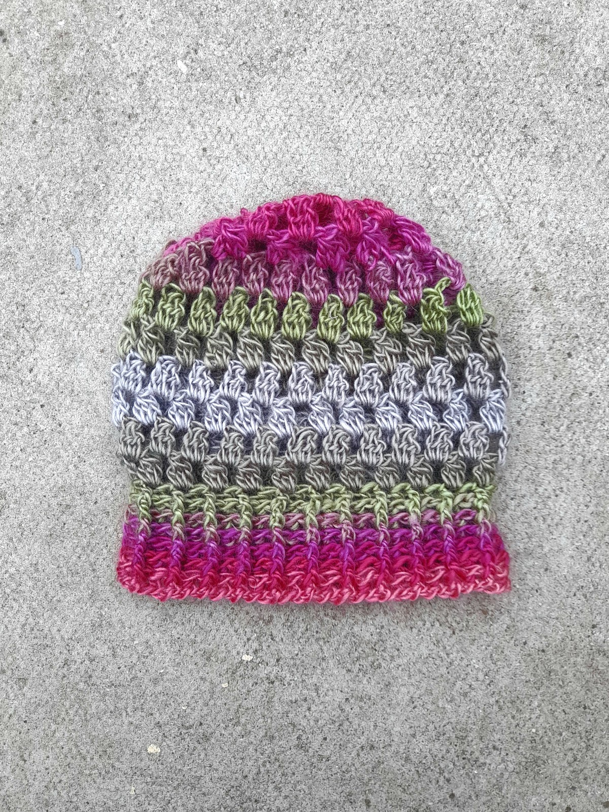 worsted weight crochet beanie pattern. Image shows a granny stitch cluster hat.