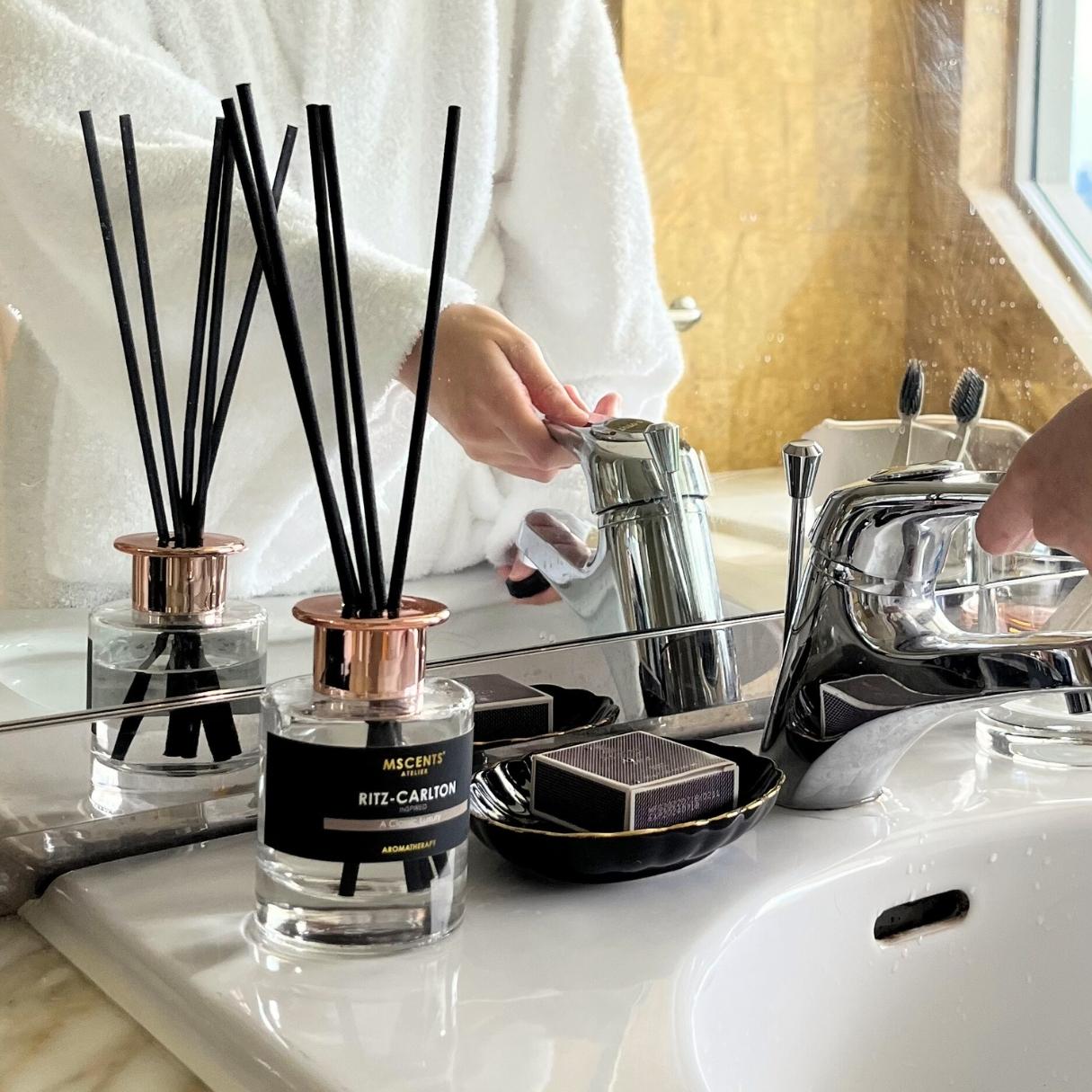 Hotel scent diffuser a person washing hands at the sink