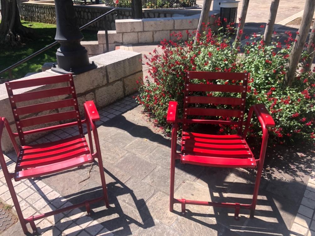 Red chairs on a patio

Description automatically generated