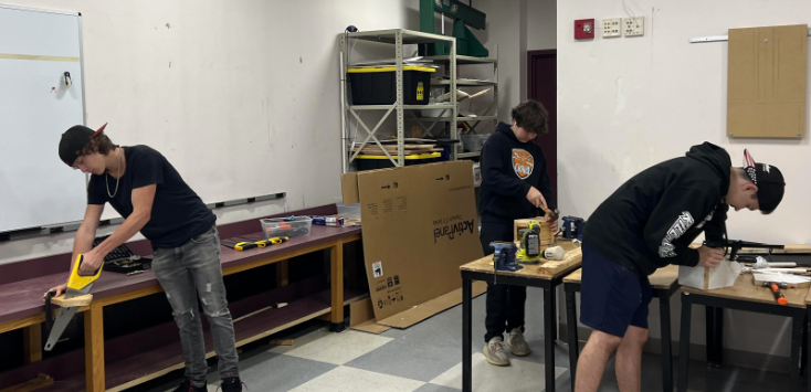 image of three students in a maintenance and repair class