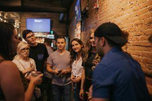 Group of young people socializing at a bar in Denver.