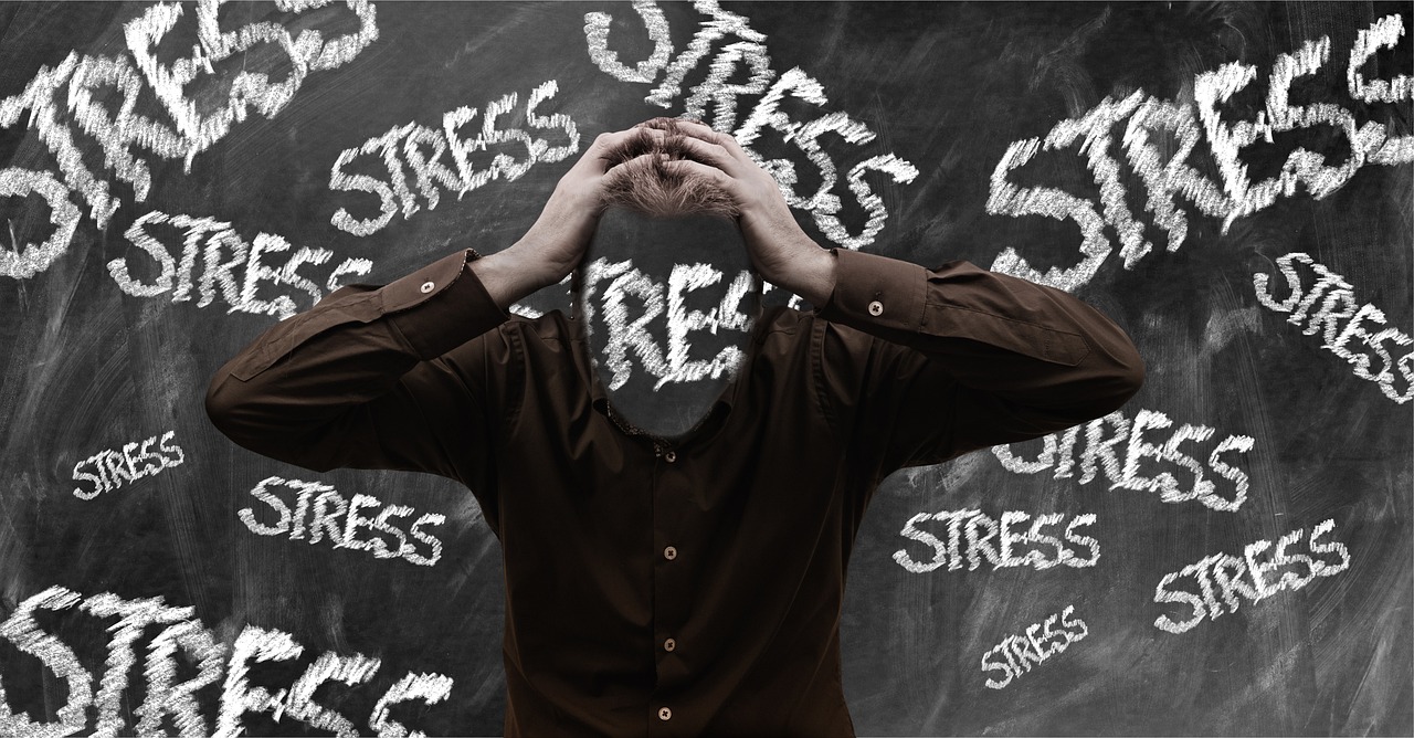 A man holding his head due to stress