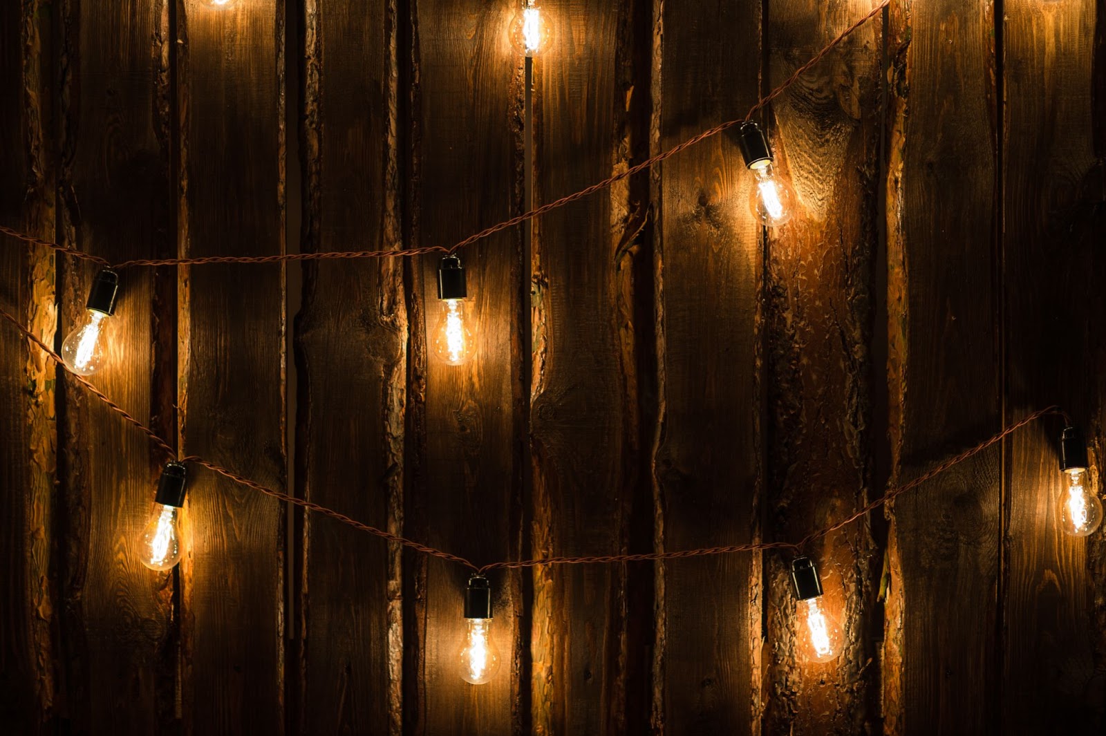 String lights on a wood fence. 