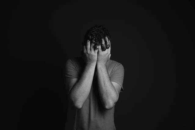 man covering his face