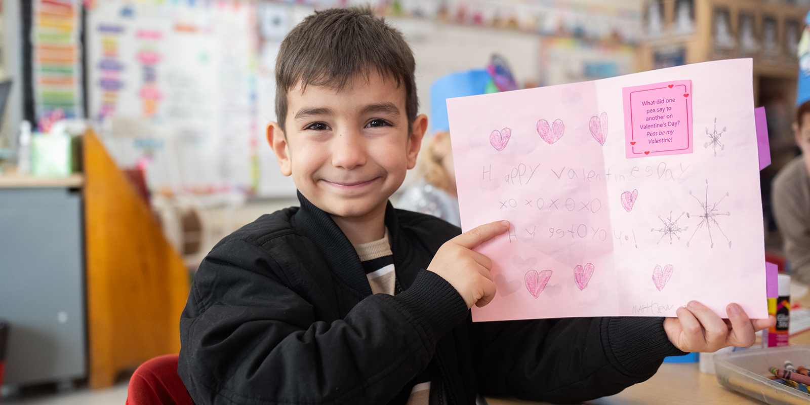 student holding handmade valentines