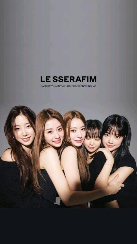 This contains an image of LE SSERAFIM group members posing together in front of a gray background with the words LE SSERAFIM on it