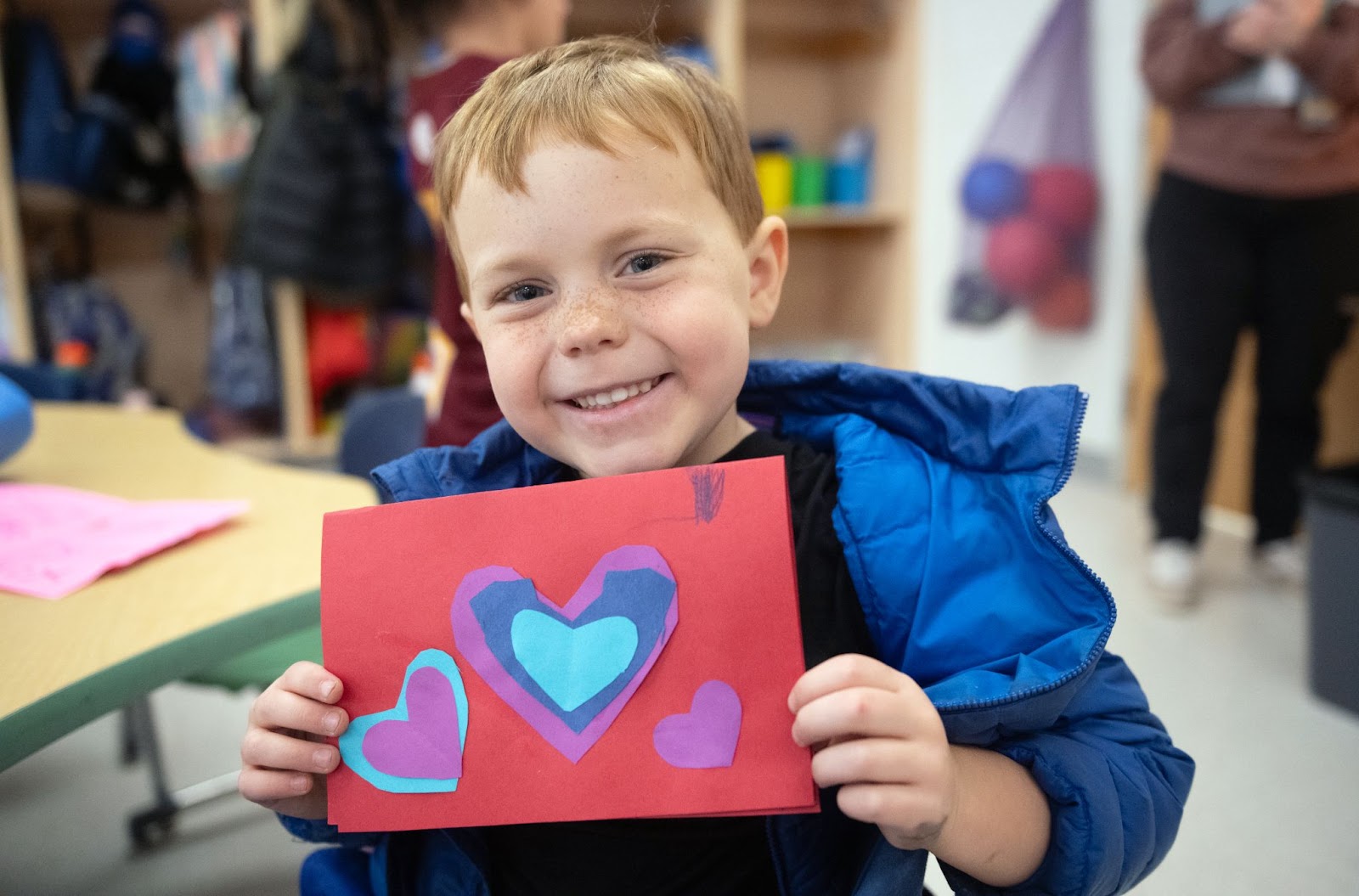 student holding handmade valentine