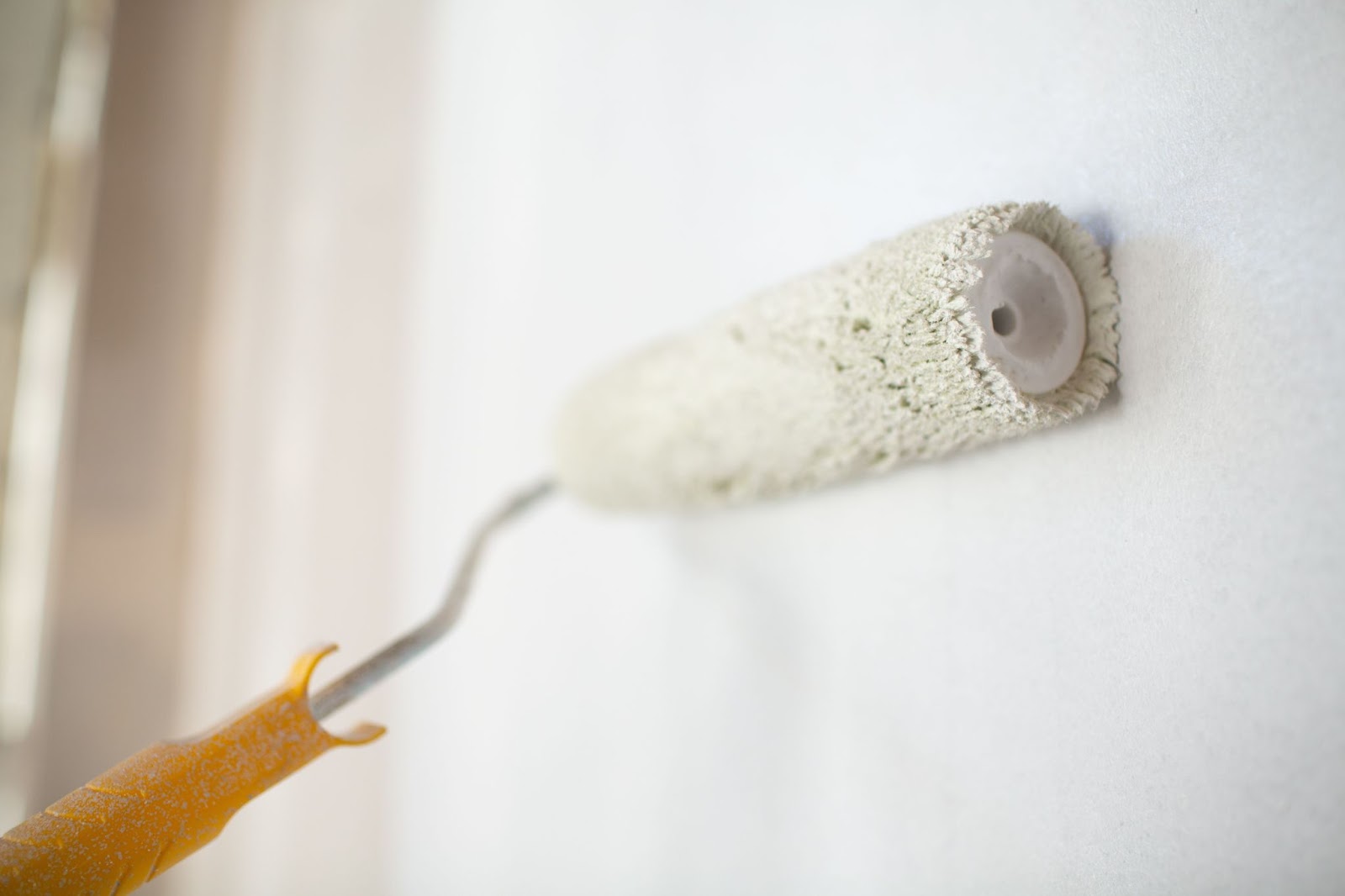 hole patching paint rolling on wall