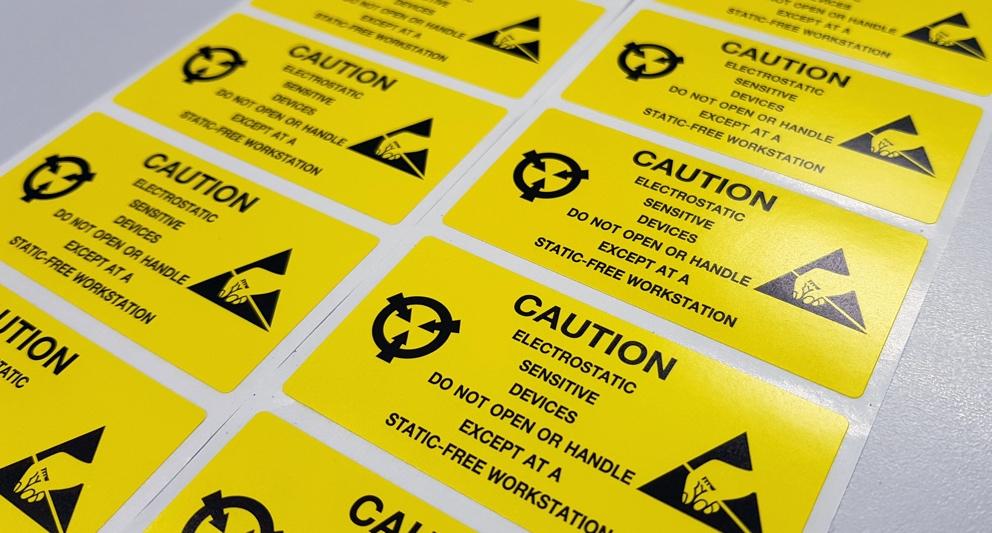 A close-up of several yellow warning signs

Description automatically generated