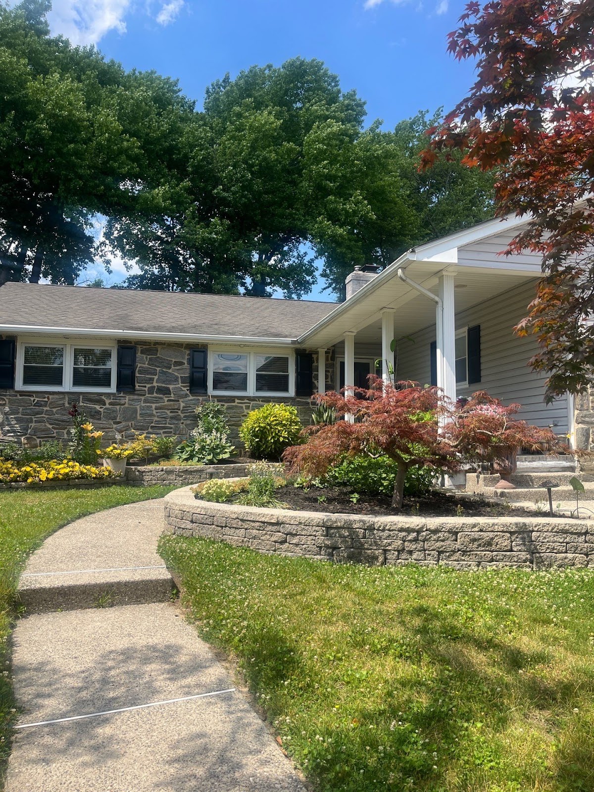 Front view of a Cherry Hill home with a well-maintained roof, highlighting a case for assessing roof repair vs replacement depending on structural and aesthetic needs.