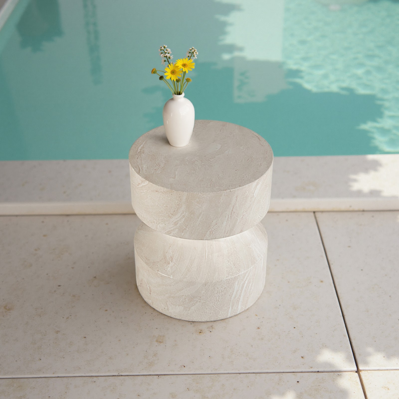 Grover Outdoor Faux Marble Hourglass Side Table featuring a symmetrical double-drum shape in a soft white stone-look finish, styled poolside with a minimalist vase—ideal for modern patios seeking sculptural elegance and weather-ready durability.