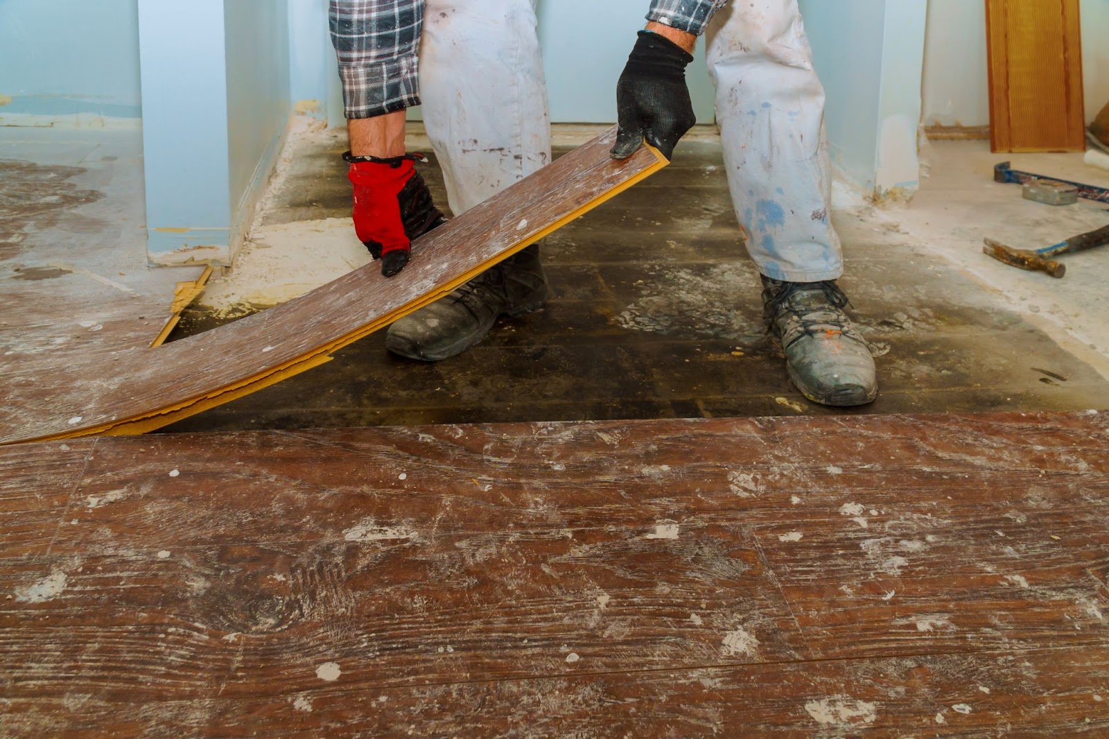 Man working on construction on wood floors. 