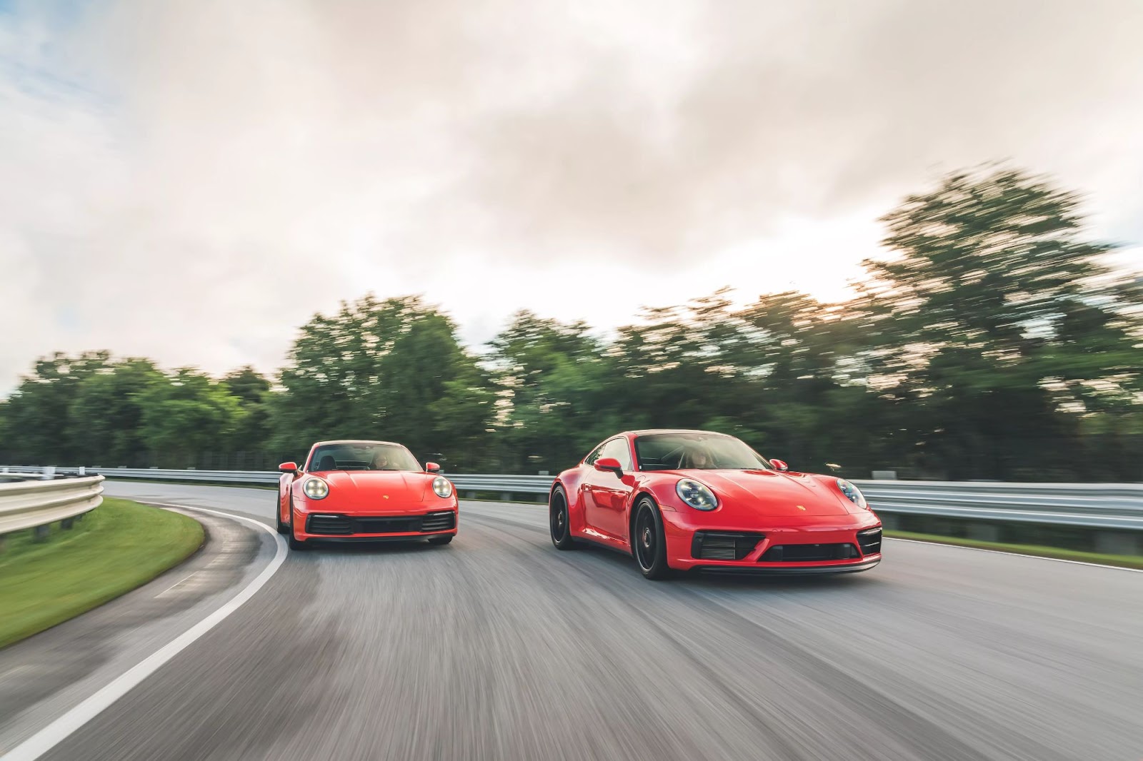 Two red Porsches racing.