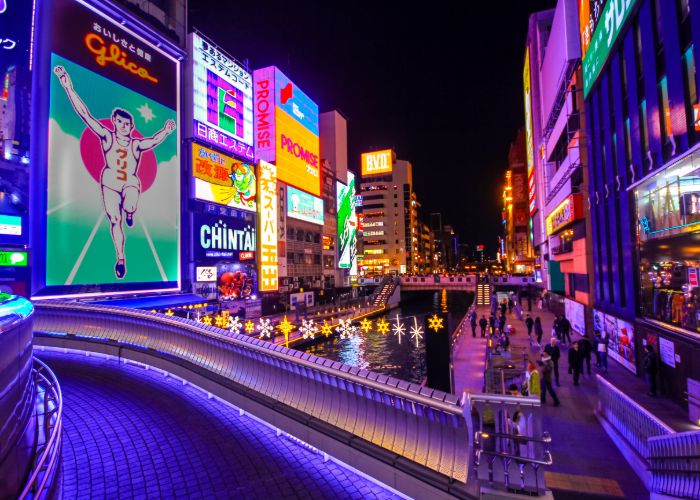 A view of Osaka's Dotonbori and Glico Man billboard with holiday lights across the canal