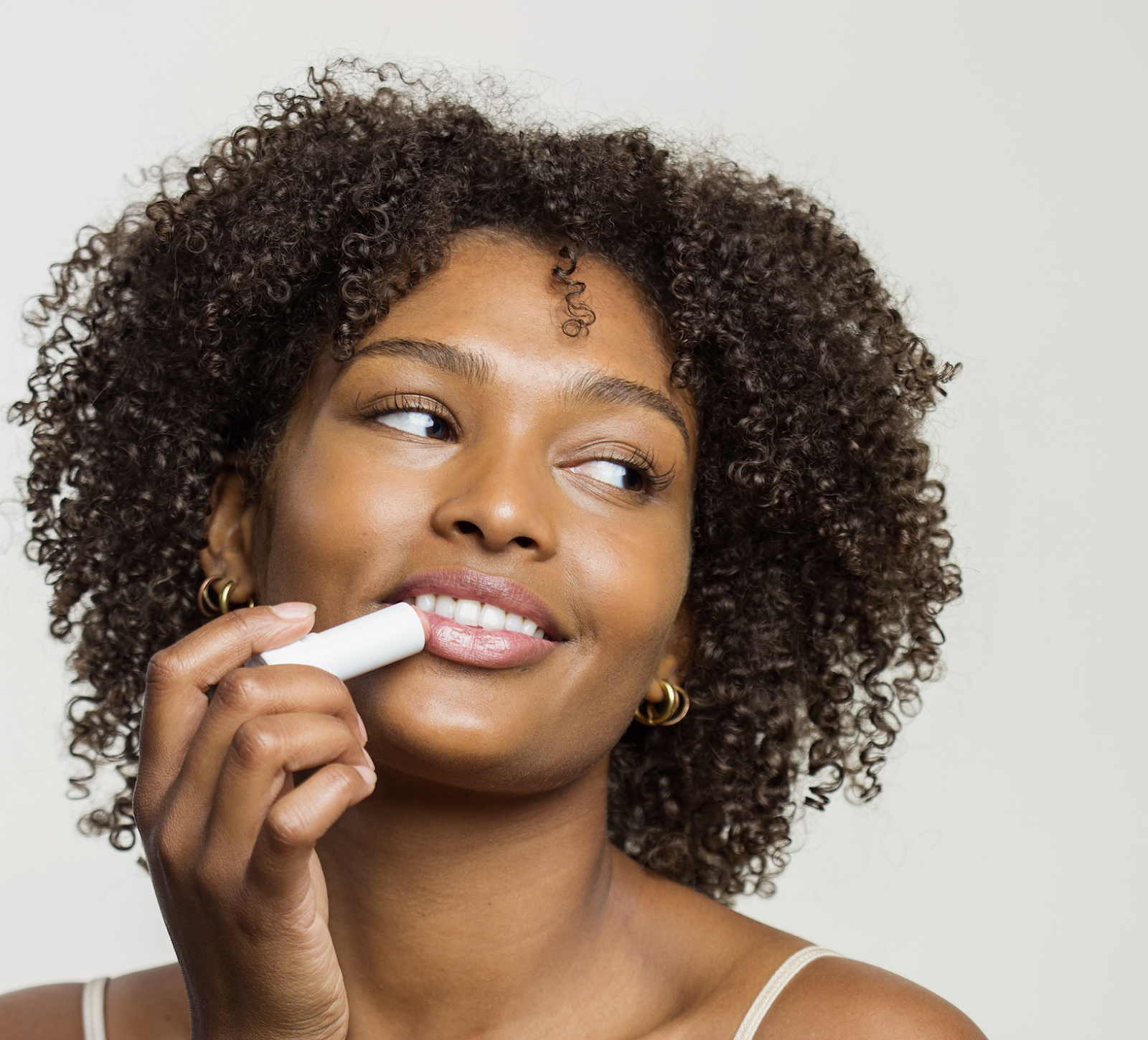 model holding up a lip balm