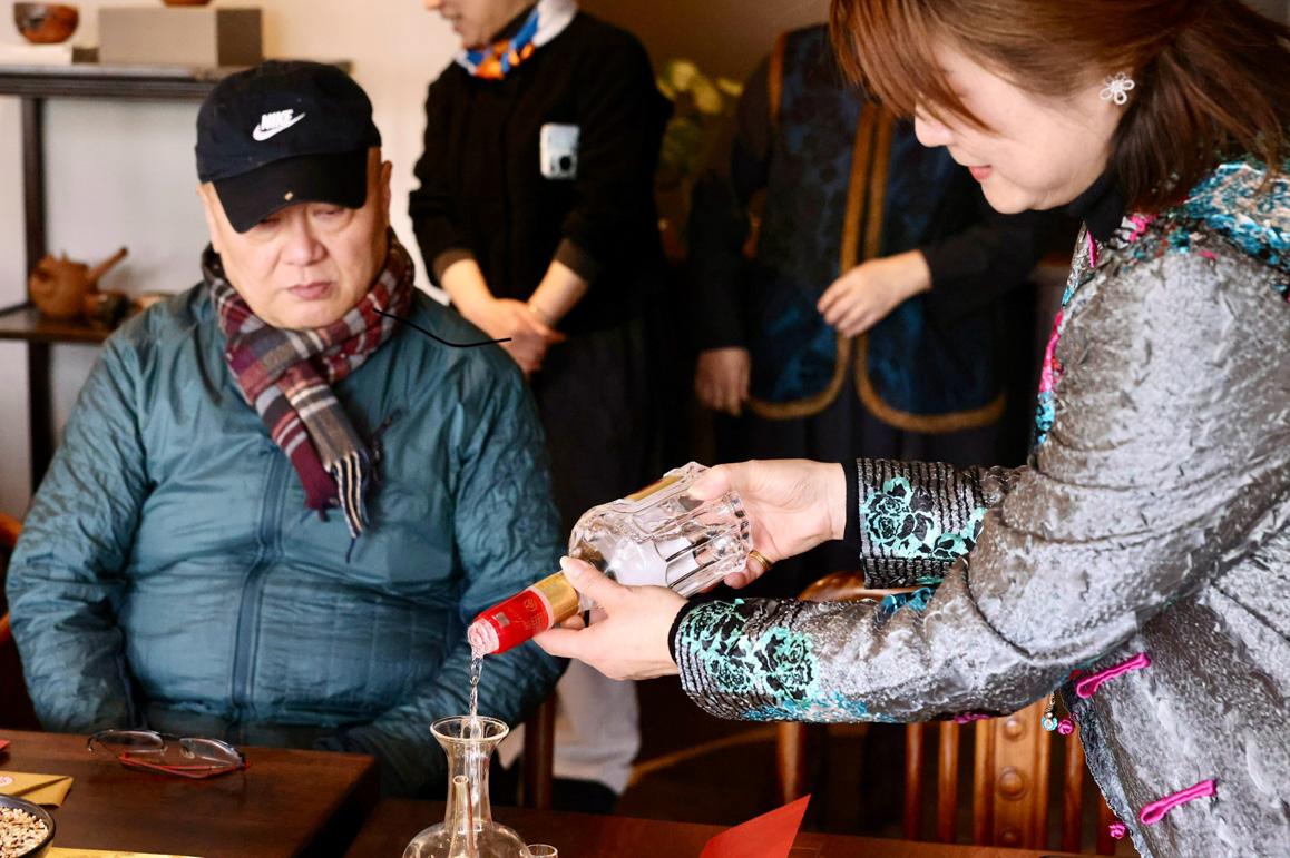 A person pouring alcohol into a glass

AI-generated content may be incorrect.