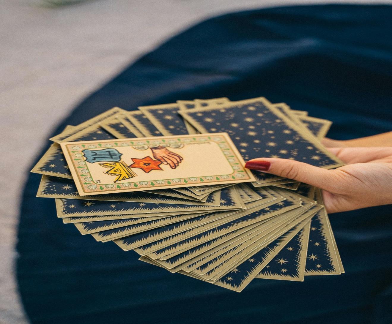A hand holding a deck of cards

AI-generated content may be incorrect.
