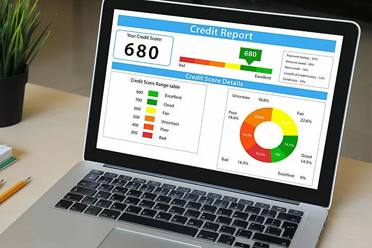 A laptop's screen reflecting a credit report 
