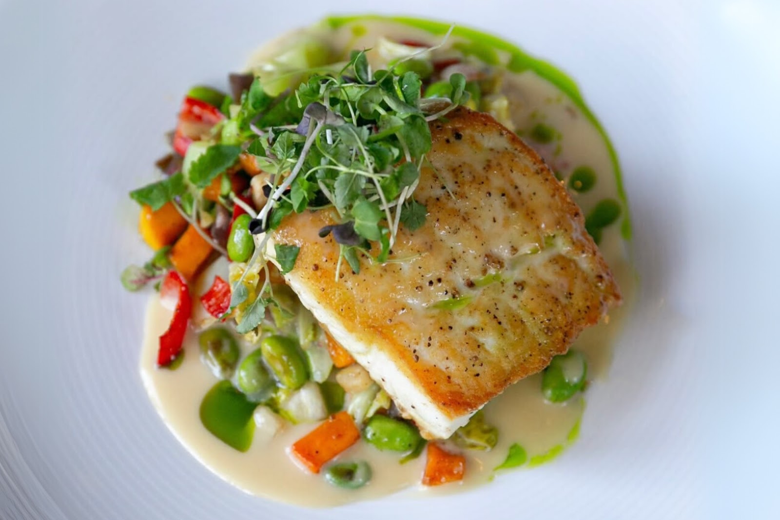 Pan-seared halibut served with vegetables