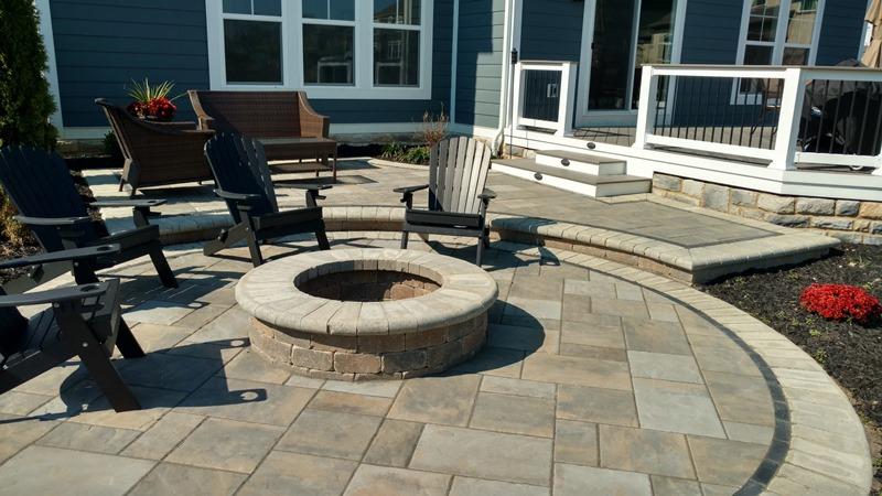 A patio with chairs and a firepit