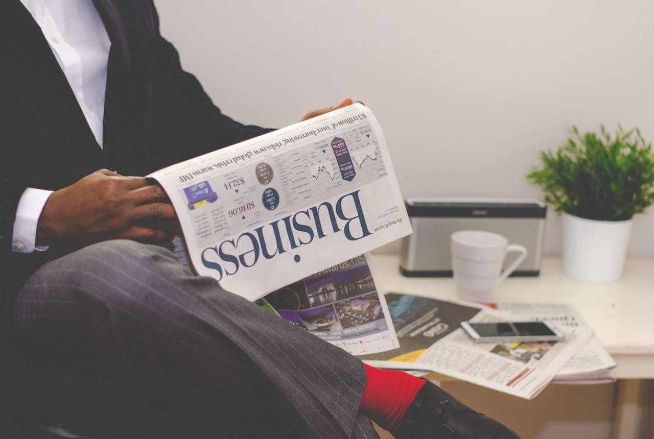 A man reading the business section of a newspaper