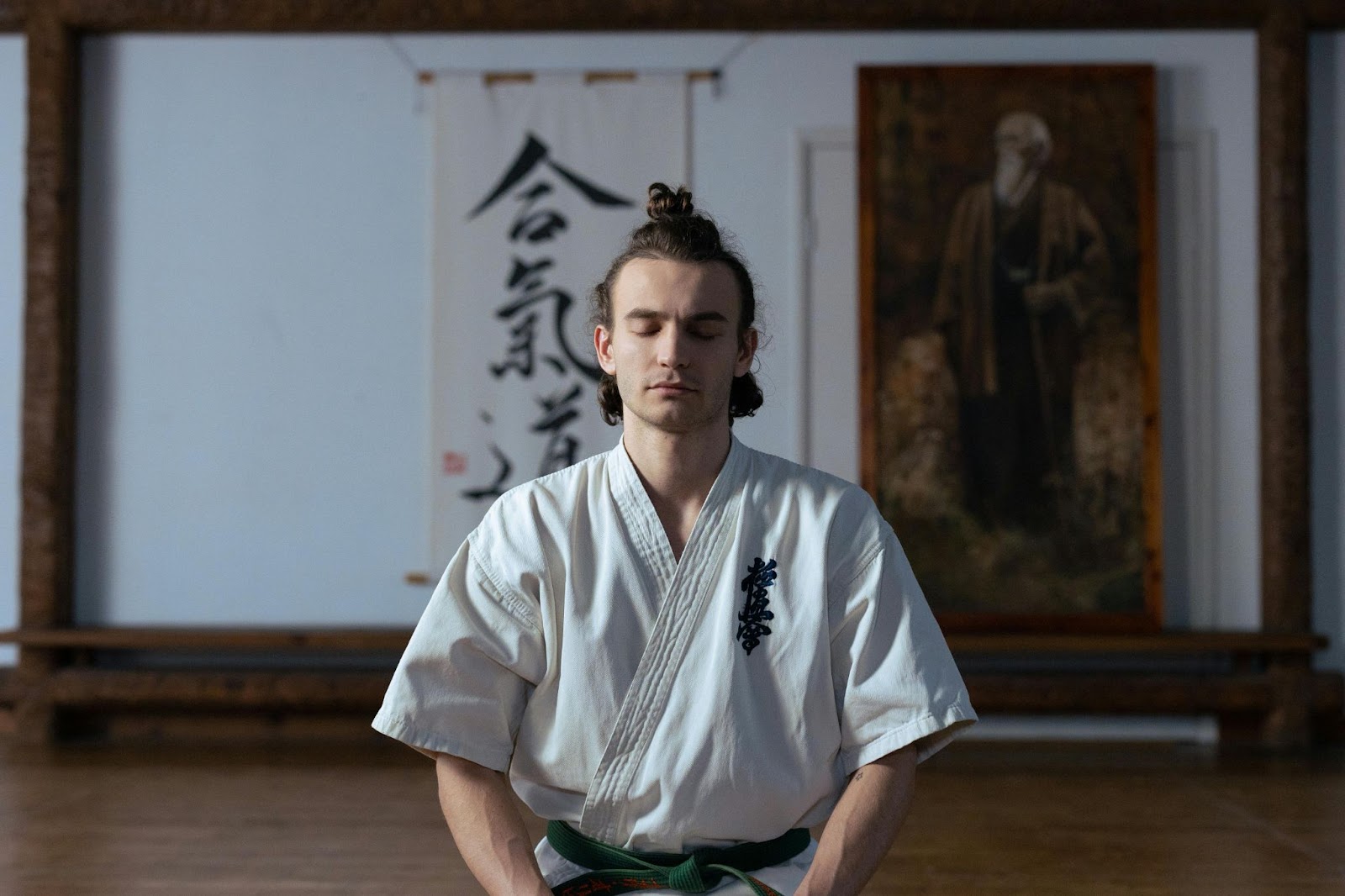 A martial arts student meditating